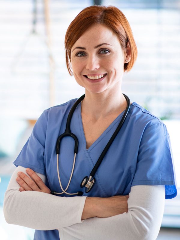 portrait-of-female-doctor-or-nurse-standing-in-hos-J37Z55D